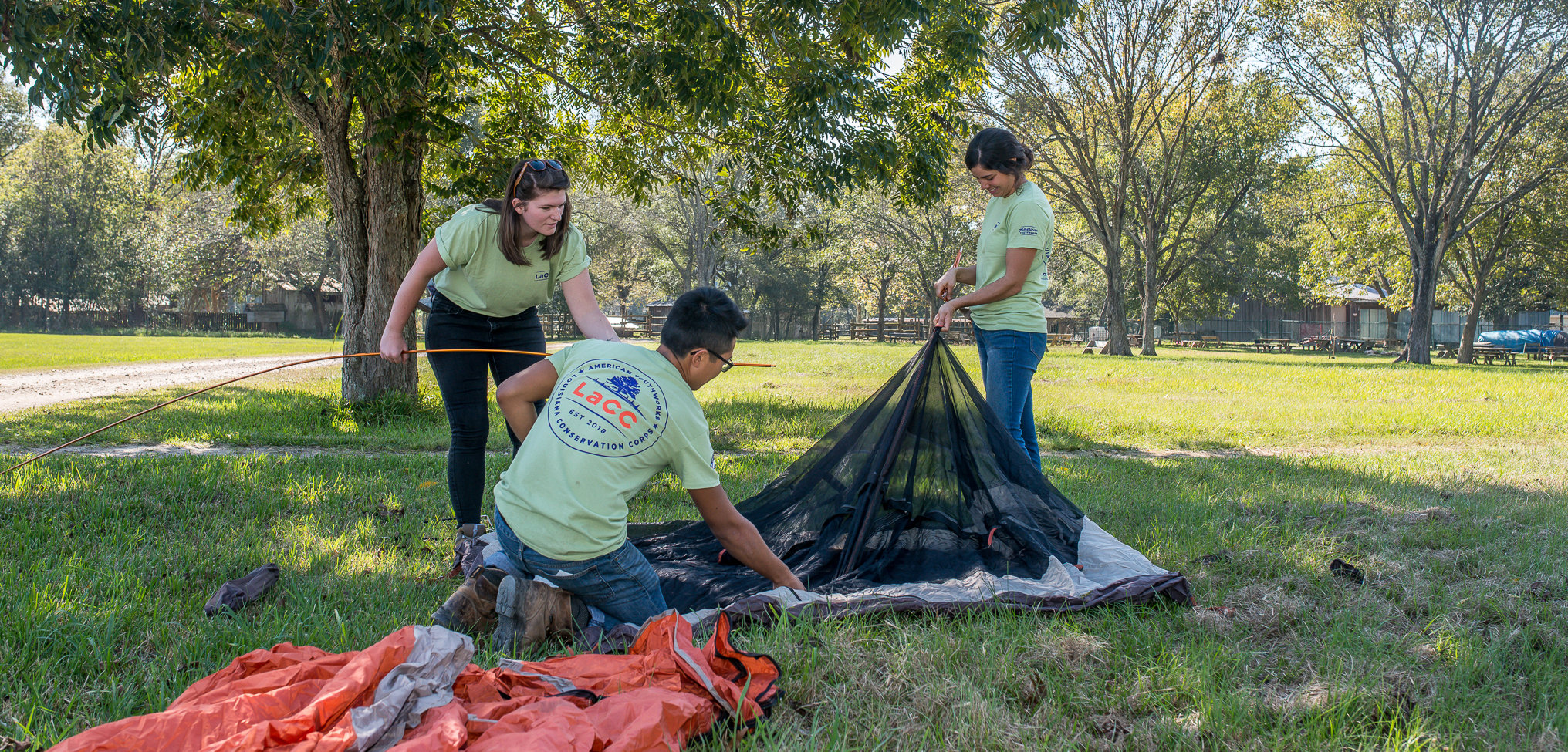 Crew members setting up a tent.