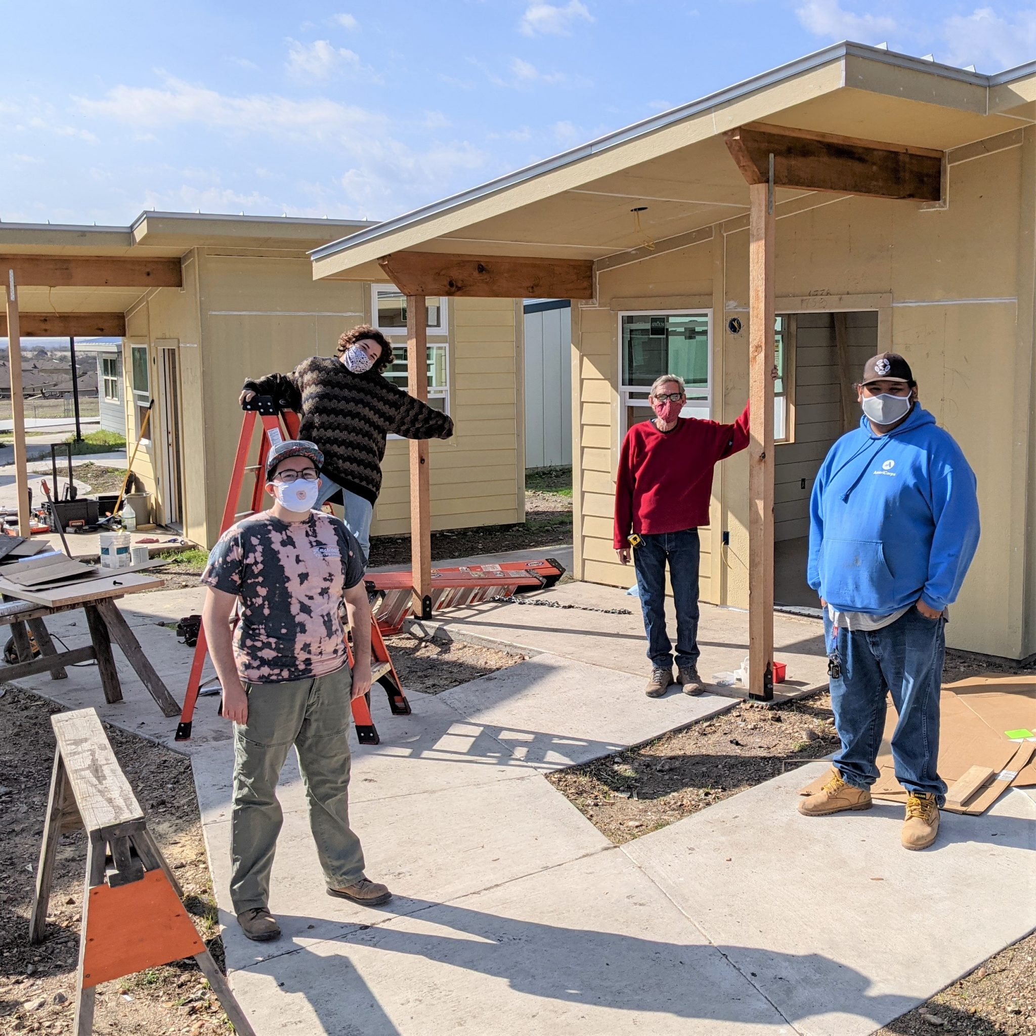 YouthBuild Austin participants standing in front of a home they built.