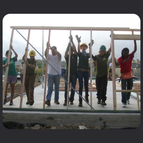 Early CVB participants building the frame of a house.